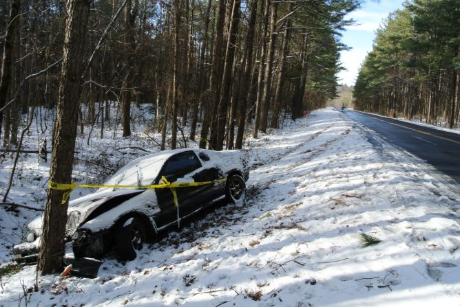 Caution tape is wrapped around a car that crashed into a tree after the driver lost control in Snellville, Georgia, on January 29.