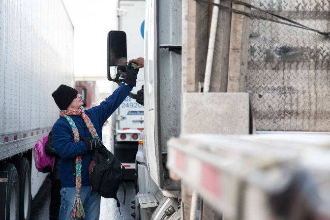 Kevin Moore hands out snacks and water to stranded motorists on Interstate 285 in Dunwoody, Georgia, on January 29.