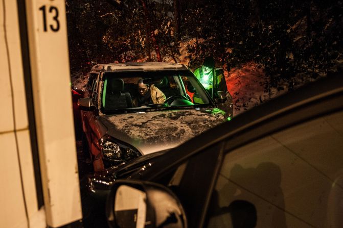 A police officer talks with a crash victim who was involved in a five-car pileup in Sandy Springs, Georgia, early on January 29.