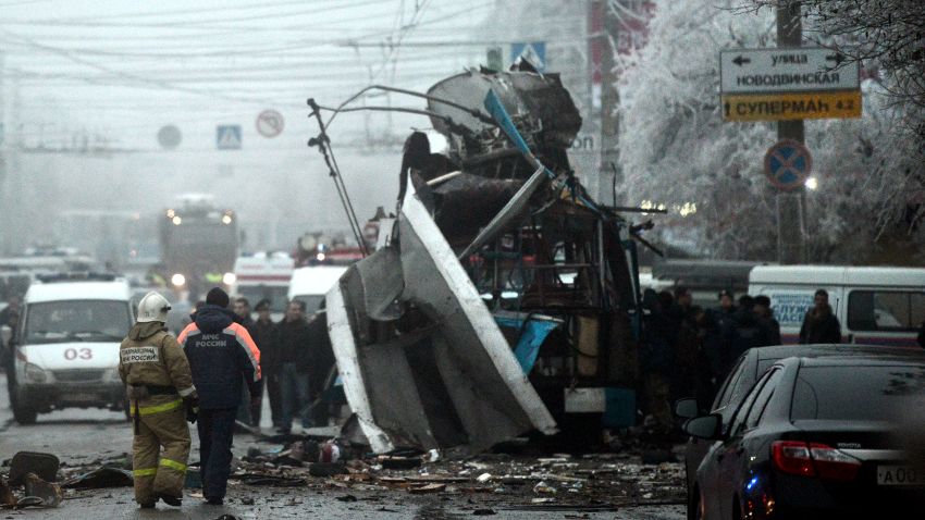 Russian firefighters and security personnel inspect the destroyed trolleybus in Volgograd on December 30, 2013.