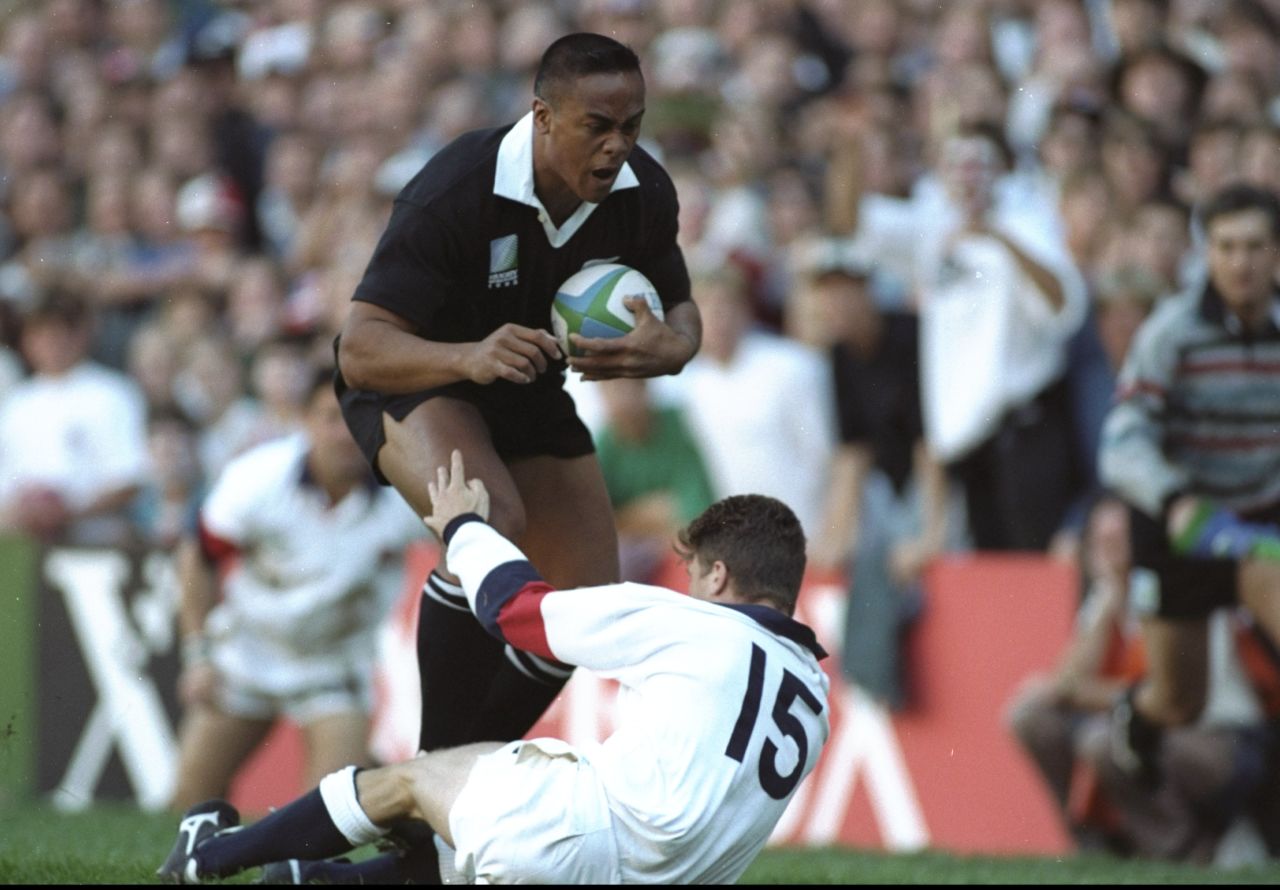 This image of Lomu bulldozing through the tackle of hapless England fullback Mike Catt as he scored one of his four tries in the semifinal in Cape Town has become one of the most iconic moments in rugby history. 
