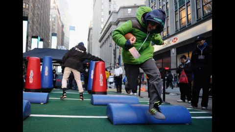 A boy completes a Super Bowl obstacle course in New York City on Wednesday, January 29. Times Square has been transformed into Super Bowl Boulevard ahead of the big game.