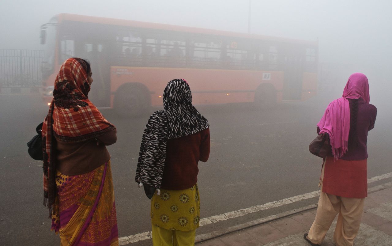 Women in Delhi struggle through the smog. The city has the world's worst pollution according to the WHO. 