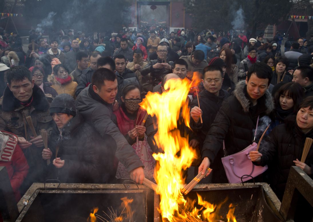 Worshippers burn incense as they pray for health and fortune at Yonghegong Lama Temple in Beijing on January 31.