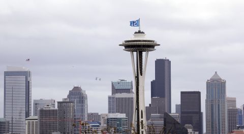 A "12th Man" flag honoring Seahawks fans billows in the wind atop the Space Needle in Seattle on January 30.