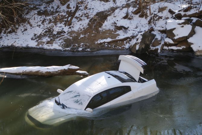 A car lies half submerged in the Cahaba River in Mountain Brook, Alabama, on Thursday, January 30. The driver was able to escape before the car slid into the river during a snow storm on Tuesday and was not injured. A wave of arctic air that started over the Midwest and Plains spread to the Southeast, bringing snow, freezing ice and sleet to a region that doesn't deal with such weather very often.