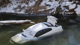 A car lies half submerged in the Cahaba River in Mountain Brook, Alabama, on Thursday, January 30. The driver was able to escape before the car slid into the river during a snow storm on Tuesday and was not injured.