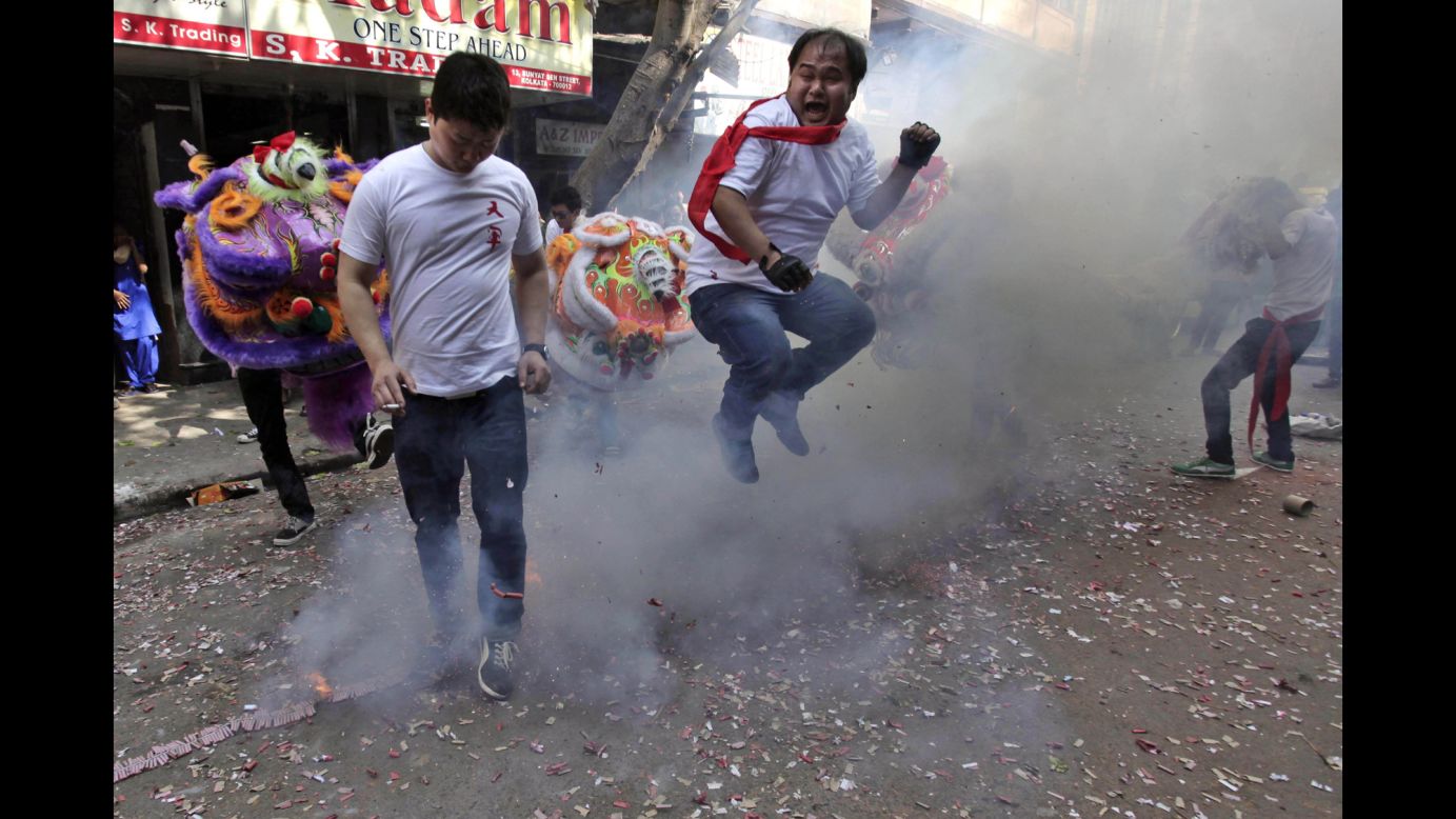 A man jumps over exploding firecrackers during celebrations in Kolkata, India, on January 31.