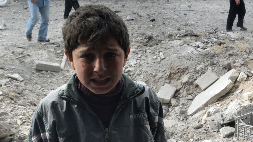 A Syrian child cries following an alleged air strike by Syrian government forces on January 30, 2014 in the northern Syrian city of Aleppo.