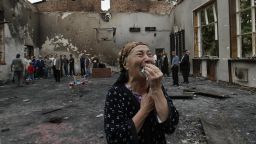 BESLAN, RUSSIAN FEDERATION: A woman cries in the ruins of the school gymnasium in Beslan, North Ossetia, 05 September 2004. The first funerals for the hundreds killed in the Russian hostage siege took place in Beslan, an AFP correspondent reported. Some 400 people were killed as a result of the three-day school siege in southern Russia, the RIA-Novosti agency quoted the spokesman for the regional president as saying 05 September 2004. AFP PHOTO / VIKTOR DRACHEV (Photo credit should read VIKTOR DRACHEV/AFP/Getty Images)