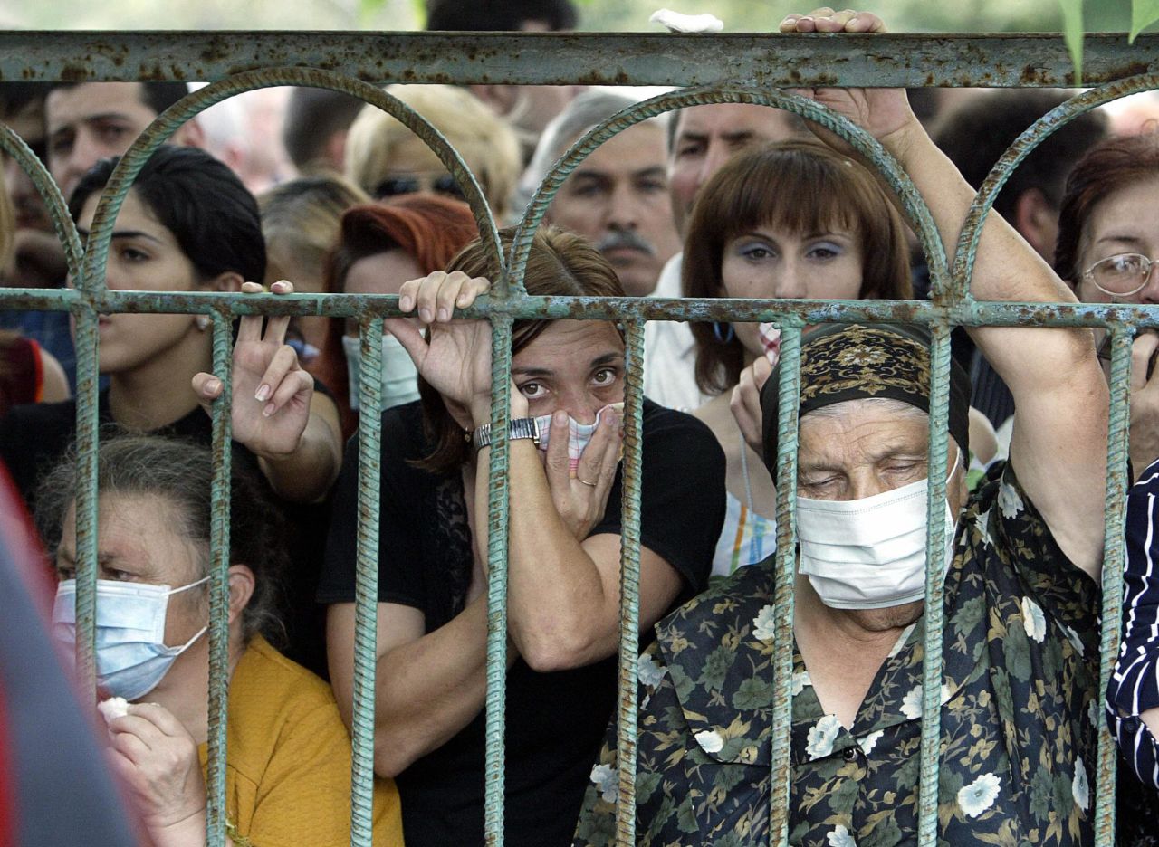 People look for their relatives among the bodies of the Beslan siege victims at the morgue in Vladikavkz, North Ossetia, on September 4, 2004.
