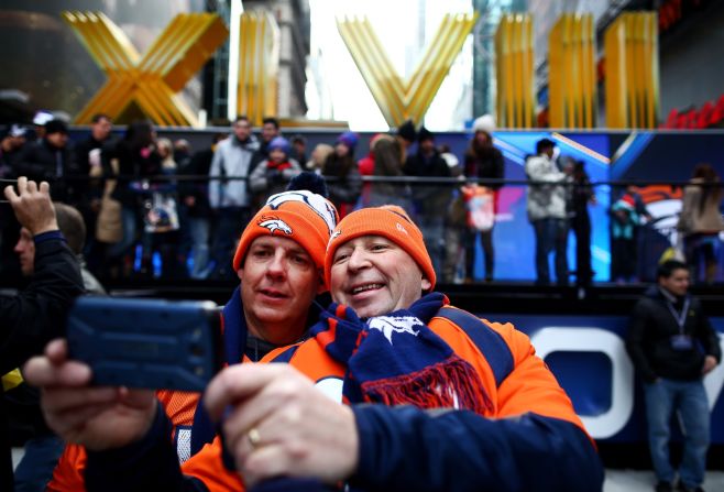 Denver Broncos fans photograph themselves during Super Bowl festivities in New York's Times Square on Friday, January 31. 
