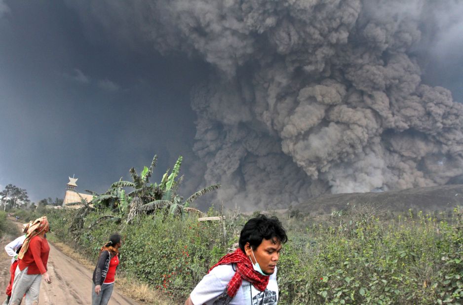 Villagers flee as Mount Sinabung erupts on February 1, in North Sumatra, Indonesia.