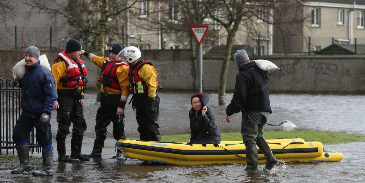 Residents use a boat to navigate flood waters after a flash flood on Saturday, February 1, in Limerick City, Ireland.