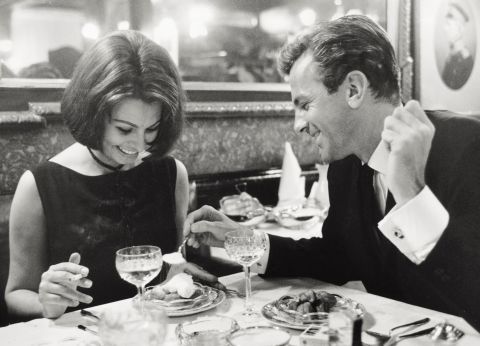 Loren has dinner with Schell at a restaurant in Hamburg, Germany, during the filming of "The Condemned of Altona" in 1962.