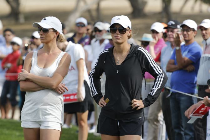 His fiancee, tennis player Caroline Wozniacki, looks on (right) as the Northern Irishman comes close to securing a $2.5 million prize for a hole-in-one at the 17th hole on the Majlis Course.