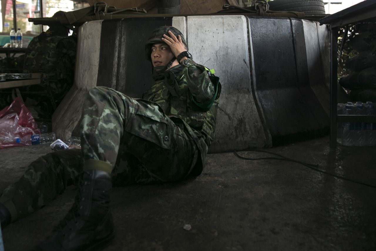 A soldier takes cover as violence escalates before the elections on February 1.