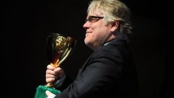 US actor Philip Seymour Hoffman poses with the Coppa Volpi for the Best Actor he received with US actor Joaquin Phoenix for "The Master" during a photocall after the award ceremony of the 69th Venice Film Festival on September 8, 2012 at Venice Lido.    AFP PHOTO / TIZIANA FABI        (Photo credit should read TIZIANA FABI/AFP/GettyImages)