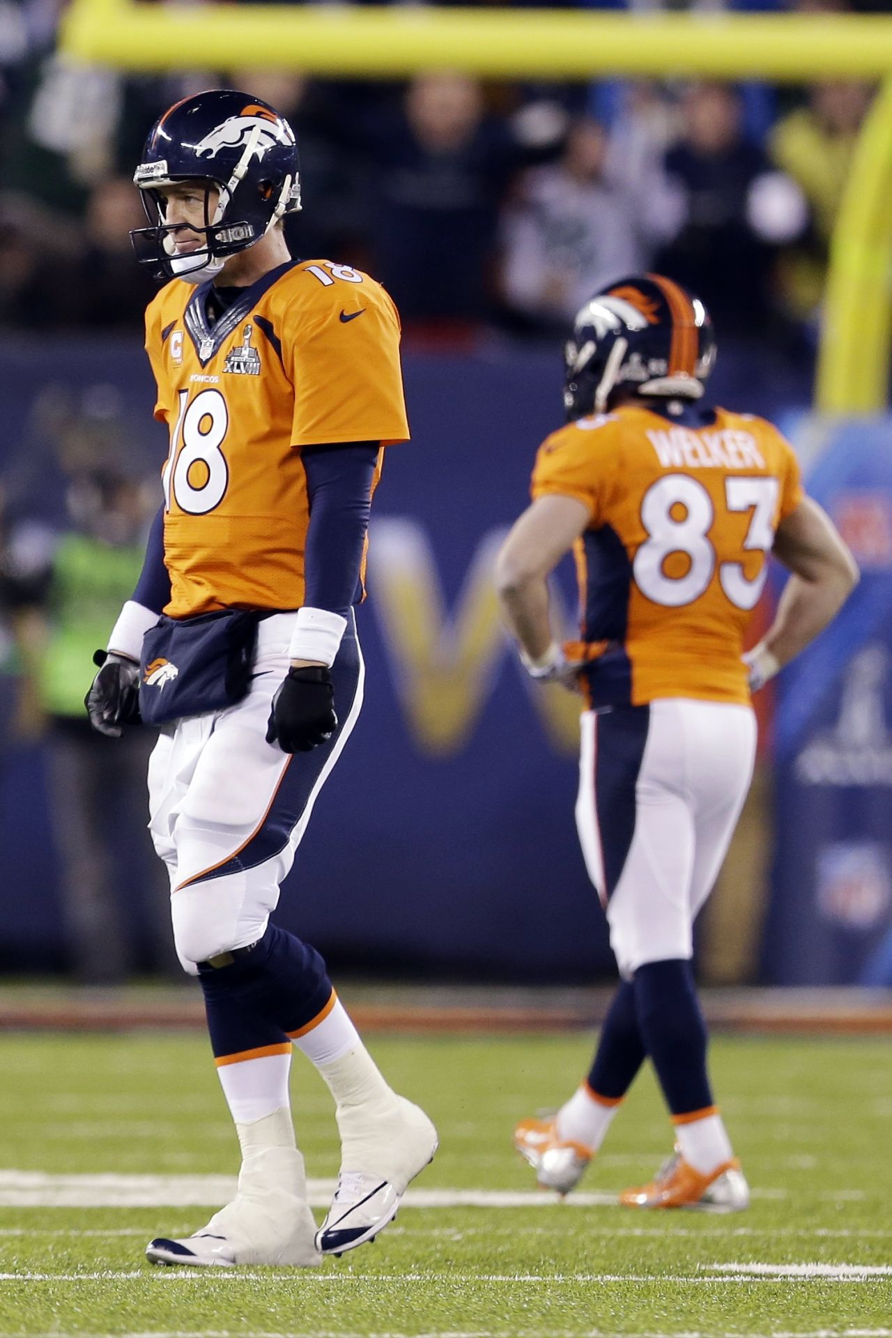 Manning (18) cuts a dejected figure after he walks off the field after being intercepted.