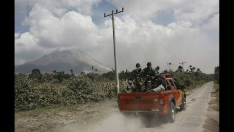 Indonesian soldiers ride in a truck in Payung village on February 3 to search for victims of the eruption.