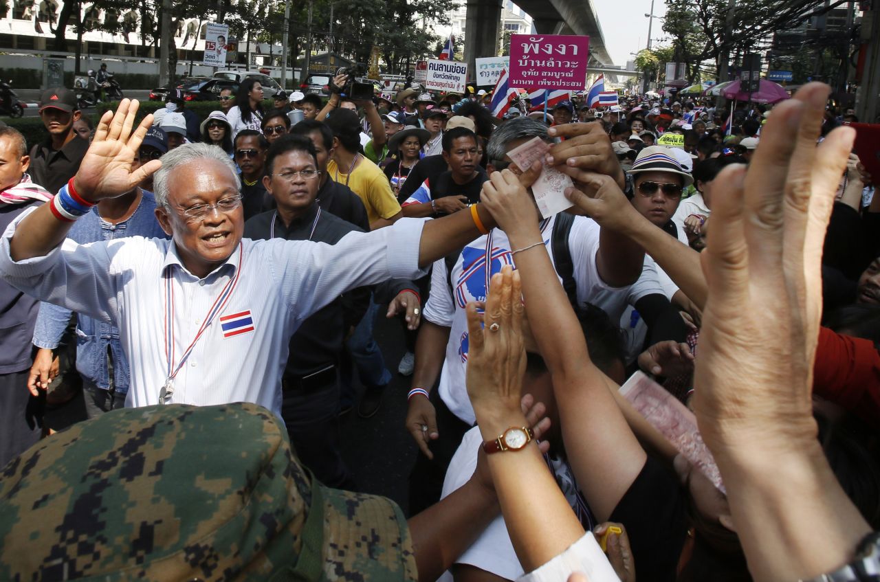 Protest leader Suthep Thaugsuban greets supporters during a march in Bangkok, Thailand, on Monday, February 3. Anti-government protesters disrupted voting in roughly one-fifth of Thailand's electoral districts in national elections Sunday, February 2, authorities said.