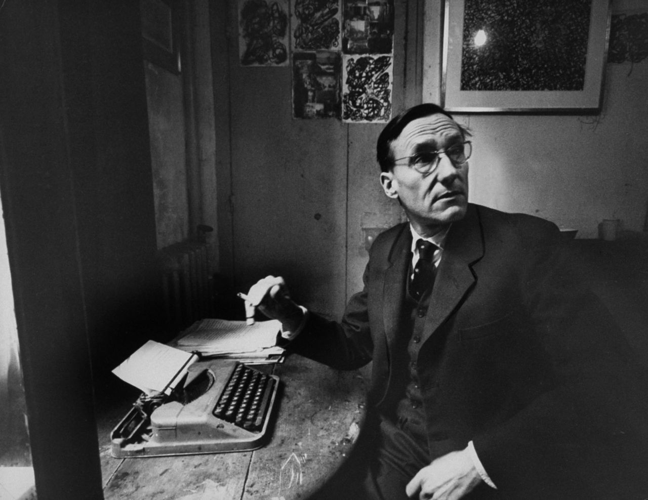 Author William S. Burroughs sits with a typewriter in 1959.