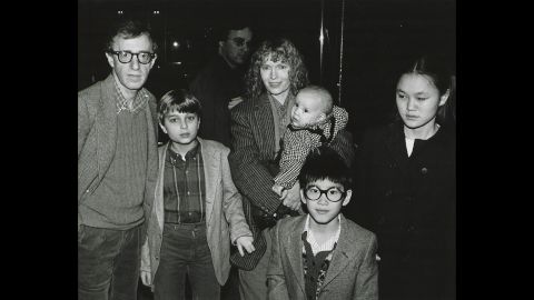 Mia Farrow has had 15 children, including three biological offspring with former husband composer Andre Previn, son Satchel (later known as Ronan) born during her relationship with Allen and several children she adopted. Here, she poses with Allen and her children, from left, Misha, Dylan (in Farrow's arms), Fletcher, and Soon-Yi in New York in 1986. The man in center background is unidentified. 