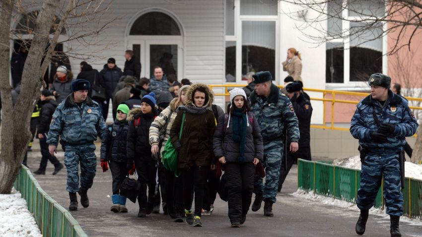 Pupils of Moscow school number 263 leave the building escorted by policemen on February 3, 2014. An armed student entered a Moscow school on Monday and took more than 20 teenagers hostage in an incident that also claimed the lives of a policeman and a teacher, security officials said. The hostage-taker was one of the students of school number 263 on the northern outskirts of Moscow, police officials said. AFP PHOTO / VASILY MAXIMOVVASILY MAXIMOV/AFP/Getty Images