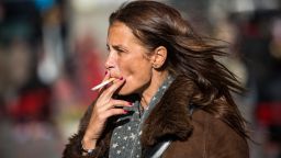 A woman smokes a cigarette on January 17 in Times Square in New York.