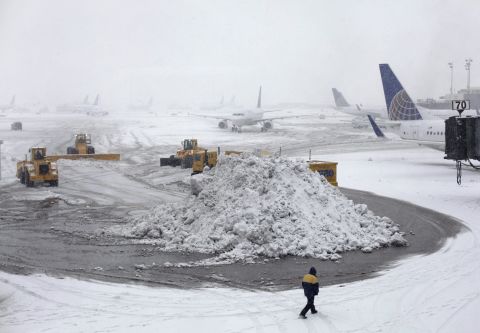 Plows clear runways February 3 at Newark Liberty International Airport.