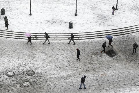 Pedestrians trudge through dirty snow and slush as they pass through New York's Union Square on February 3.