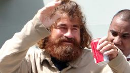 A Mexican castaway who identified himself as Jose Ivan and later told that his full name is Jose Salvador Alvarenga walks with the help of a Majuro Hospital nurse in Majuro after a 22-hour boat ride from isolated Ebon Atoll on February 3, 2014.