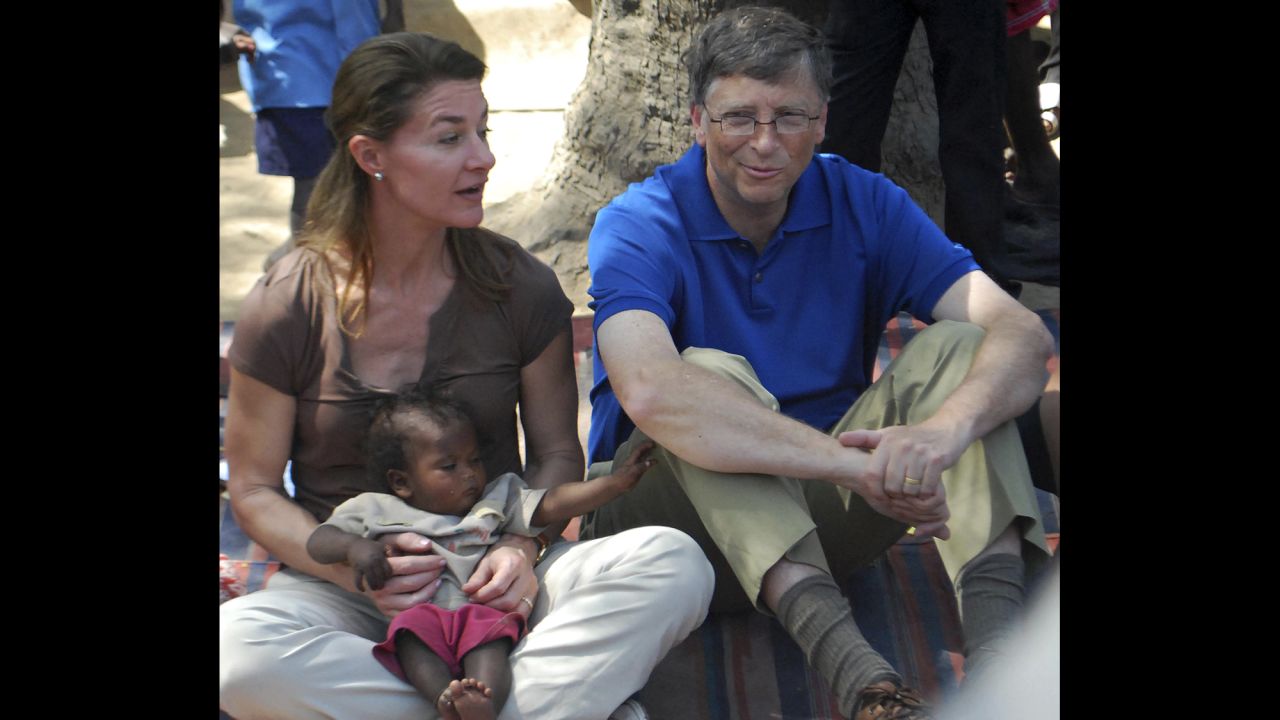 Gates looks on as his wife, Melinda, holds a baby during their visit to a village in India's Bihar state on March 23, 2011. The mission of the Bill & Melinda Gates Foundation is to "unlock the possibility inside every individual," according to its website.