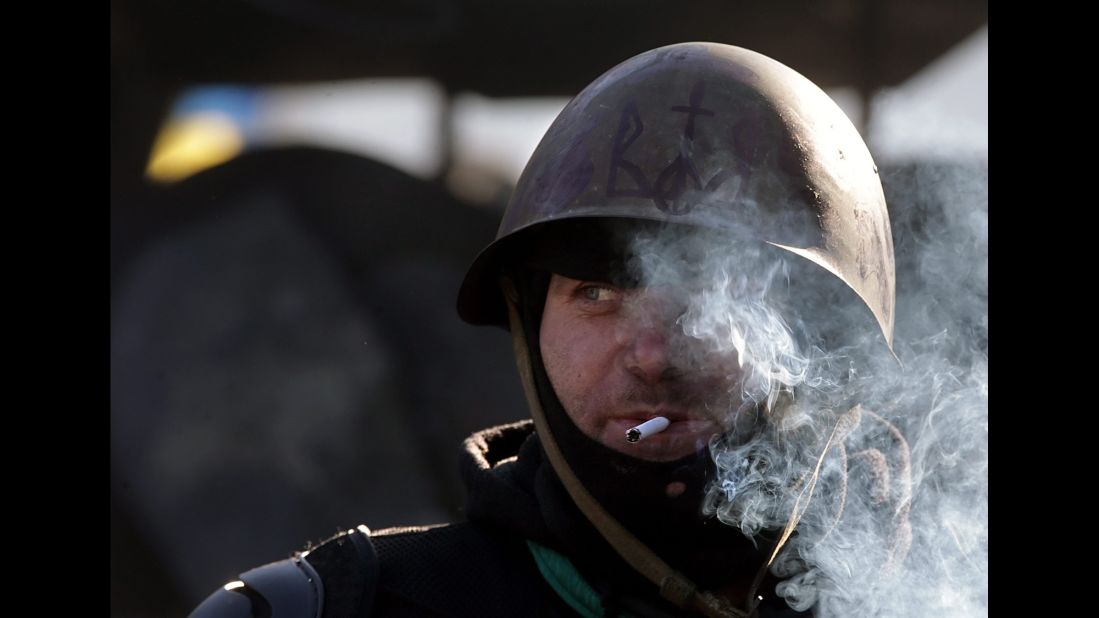 A protester smokes a cigarette while standing guard in Kiev on February 4.