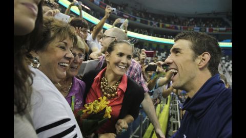 American swimmer Michael Phelps shares a joke with his mother, Debbie, left, and his sister Hilary after a race at the World Championships in Shanghai, China, in 2011.