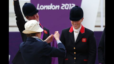 British Olympian Zara Phillips is presented with a silver medal by her mother, Princess Anne, after an equestrian event in the 2012 Olympics.