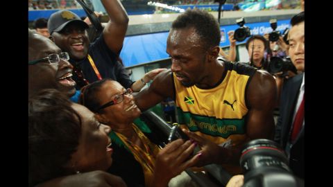 Jamaican sprinter Usain Bolt celebrates victory and a new world record with his mother, Jennifer Bolt, following a race at the World Championships in Daegu, South Korea, in 2011.