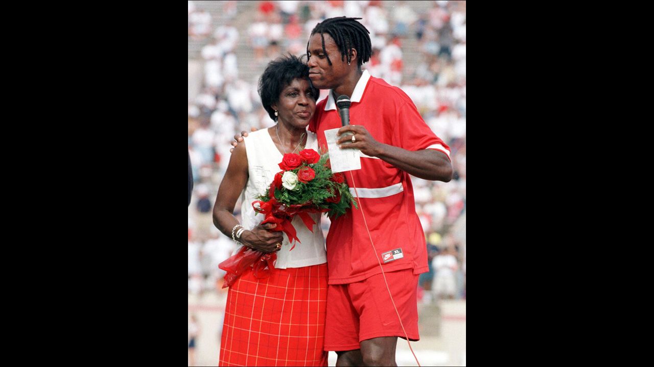 Track-and-field legend Carl Lewis hugs his mother, Evelyn, after his farewell race in Texas in 1997.