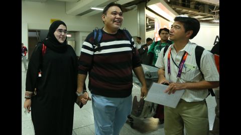 Saudi judo athlete Wojdan Shaherkani arrives with her father, Ali, for the 2012 Olympic Games.