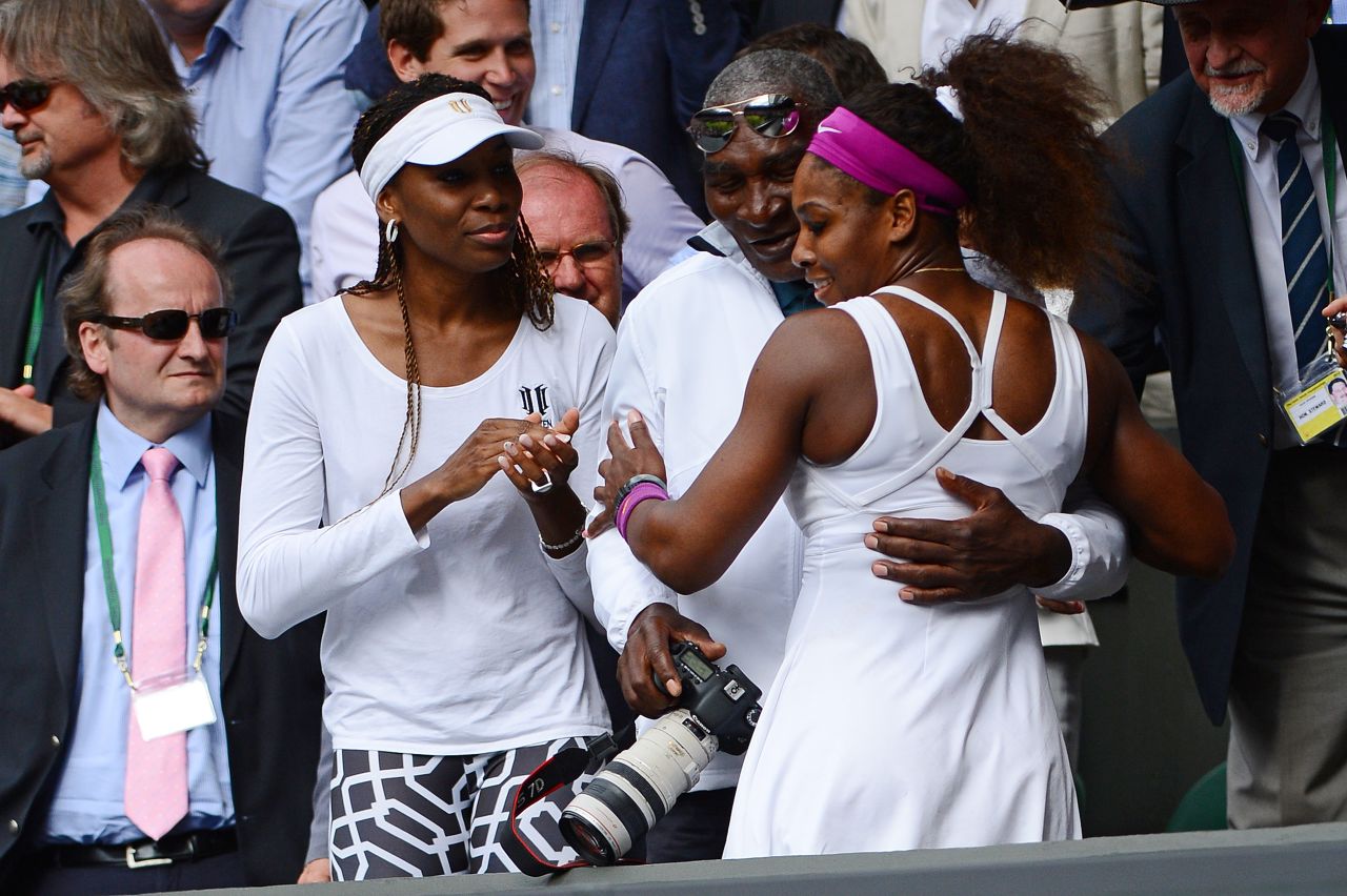 U.S. tennis player Serena Williams, right, climbs up to embrace her father, Richard, and her sister Venus after winning Wimbledon in 2012. Williams won Olympic gold later that summer.