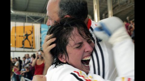 German fencer Imke Duplitzer hugs her father after an Olympic win in 2004.