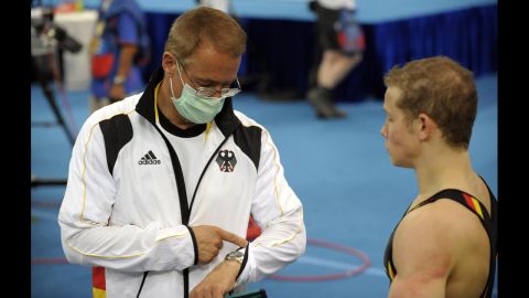 German gymnast Fabian Hambuchen, right, talks to his father and coach, Wolfgang, during a training session before the 2008 Olympics.
