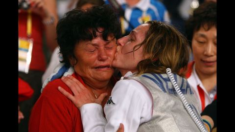 Italian fencer Valentina Vezzali kisses her mother, Enrica, after winning a gold medal at the 2008 Olympic Games.