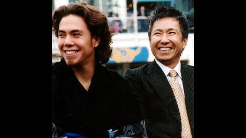 American speed skater Apolo Anton Ohno and his father, Yuki, smile as Apolo Anton Ohno Day is announced in Seattle in 2002.