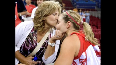 Basketball player Becky Hammon receives a kiss from her mother, Bev, at the 2008 Olympic Games. Hammon played for Russia.