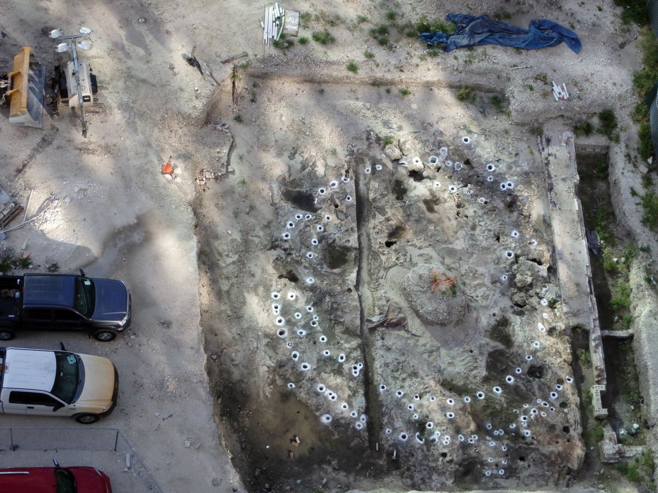 A network of holes lay out the foundations of a Tequesta settlement. The ancient tribe lived in what is now metro Miami until the 1700s, and the holes held pine posts that framed their thatched buildings.