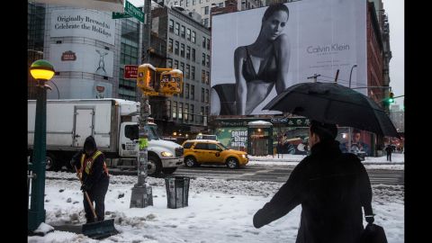 A woman shovels snow in New York's SoHo neighborhood on Wednesday, February 5.