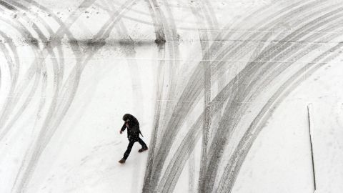 A person crosses a snowy parking garage in Owensboro, Kentucky, on February 4.