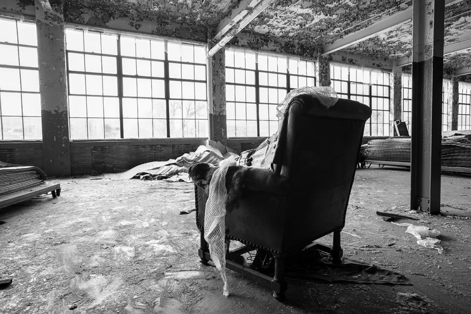Taken outside the factory's famous bowling alley, this photo features a rather out-of-place leather chair facing the many large windows. 