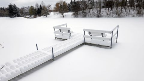 Snow piles up on a dock near a frozen pond in Carmel, Indiana, on February 5.